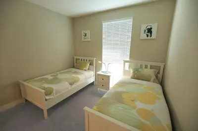 a bedroom with two beds and a window at Downtown Cosmopolitan Residences in Los Angeles