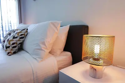 a lamp sitting on a table next to a couch at Downtown Cosmopolitan Residences in Los Angeles