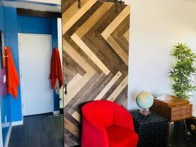 two pictures of a room with a red chair and a door at Luxe in Hollywood Hills- modern oasis, pool 5 min to Sunset in Los Angeles