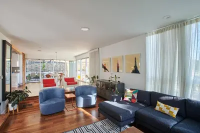 a living room with a blue couch and chairs at Luxe in Hollywood Hills- modern oasis, pool 5 min to Sunset in Los Angeles
