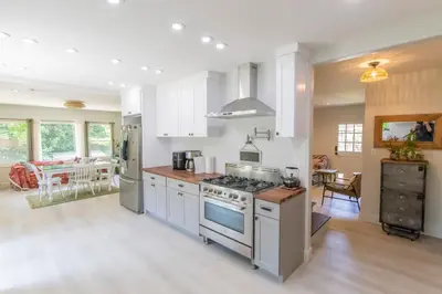 a kitchen with white cabinets and a stove top oven at Oasis Hollywood in Los Angeles