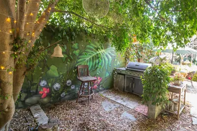 a chair sitting next to a wall with a stove at Oasis Hollywood in Los Angeles