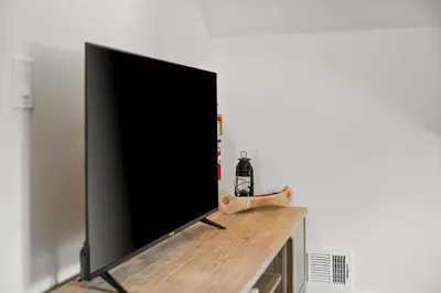 a flat screen tv sitting on top of a table at Luxe Lakefront with Hot Tub, Fire Pit, Game Room, Boat Dock in Big Bear Lake