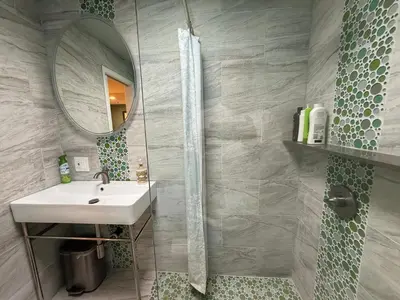 a bathroom with a sink and a mirror at Pasadena Old Town Cottage in Pasadena