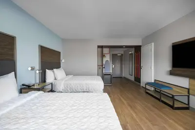 a hotel room with two beds and a flat screen tv at Tru by Hilton Norco Eastvale in Norco