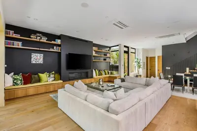 a living room with a large couch and a television at The Bella Villa Venice Beach - luxury interior design - spa and terrace in Los Angeles