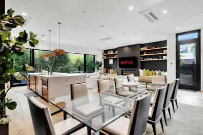 a dining room with a glass table and chairs at The Bella Villa Venice Beach - luxury interior design - spa and terrace in Los Angeles