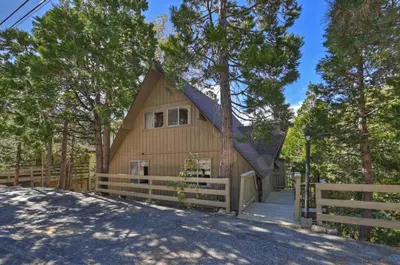 a house with a fence in front of it at Lake Arrowhead Charming Chalet in Lake Arrowhead