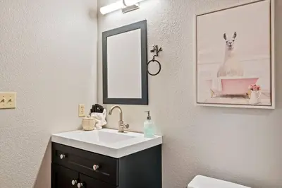 a bathroom with a sink and a mirror at Big Bear Lake Sleep 16 in Big Bear Lake