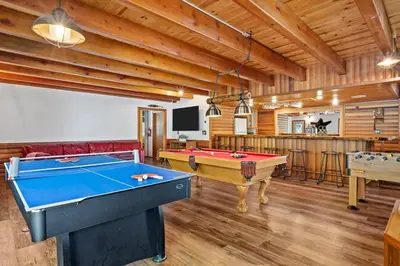 a living room with a pool table and a tv at Big Bear Lake Sleep 16 in Big Bear Lake