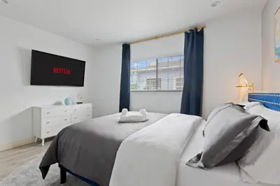 a white bedroom with a bed and a window at Luxury Oasis in Culver City! Free parking and Jacuzzi in Los Angeles