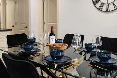 a dining table with a bottle of wine and glasses at Luxury Oasis in Culver City! Free parking and Jacuzzi in Los Angeles