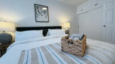 a bedroom with two beds with a basket on the bed at Cozy 2B1B Apt Prime Location Newly Remodeled in Alhambra