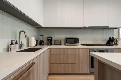 a kitchen with a sink and a microwave at The Sapphire Nest - Spectacular Rooftop Amenities Ocean views 2BR in Los Angeles
