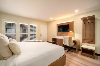 a bedroom with a bed and a desk and a television at LYFE INN & SUITES by AGA - Beverly Hills in Los Angeles