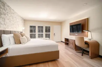 a bedroom with a bed and a desk and a television at LYFE INN & SUITES by AGA - Beverly Hills in Los Angeles