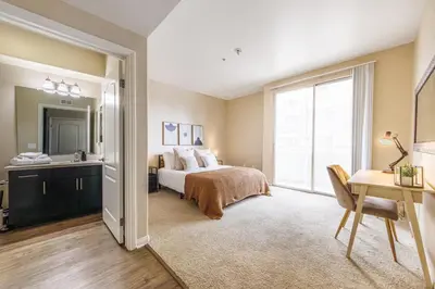 a bedroom with a bed and a desk and a window at Spacious 3-Bedroom 3BTH Apt in Marina Del Rey! Pool, Hot Tub in Los Angeles