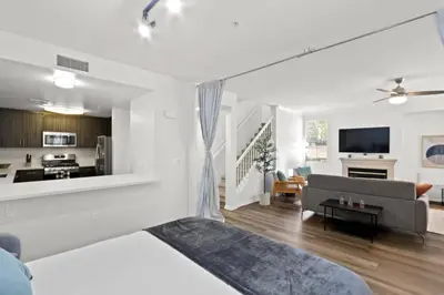 a white living room with a couch and a kitchen at 4bd Townhouse - Special Limited Time Offer near Venice Beach! in Los Angeles