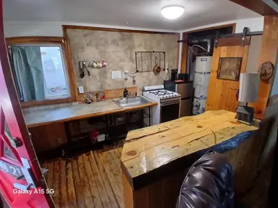 a kitchen with a wooden counter and a sink at Big Bear Lake - Tulip Lane Cabin #21 in Big Bear Lake