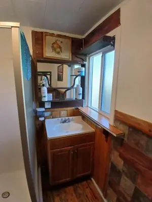 a bathroom with a sink and a mirror at Big Bear Lake - Tulip Lane Cabin #21 in Big Bear Lake
