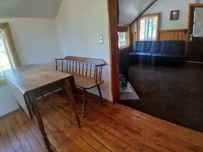 a living room with a table and a couch at Big Bear Lake - Tulip Lane Cabin #22 in Big Bear Lake