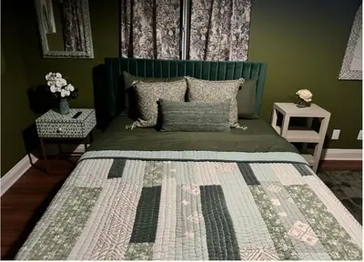 a green bedroom with a bed with a green headboard at Cozy and Spacious Duplex in Los Angeles