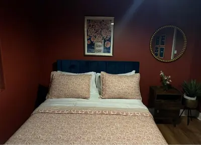 a bed with a blue headboard in a bedroom at Cozy and Spacious Duplex in Los Angeles