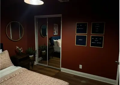 a bedroom with a mirror and a bed in a room at Cozy and Spacious Duplex in Los Angeles