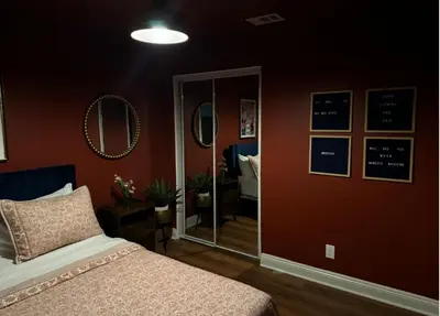 a bedroom with a bed and a mirror at Cozy and Spacious Duplex in Los Angeles