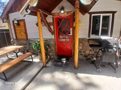 a red door on the side of a house at Big Bear Lake - Tulip Lane Cabin #24 in Big Bear Lake