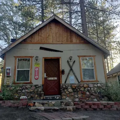 a small house with a large clock on it at Big Bear Lake - Tulip Lane Cabin #26 in Big Bear Lake