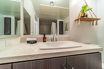 a bathroom with a sink and a large mirror at Sunset Blvd Studio Apt in the Heart of Hollywood in Los Angeles