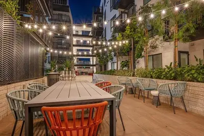 a patio with a table and chairs and lights at Sunset Blvd Studio Apt in the Heart of Hollywood in Los Angeles