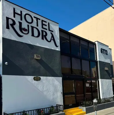 a hotel lobby with a sign on the side of a building at Hotel Rudra - Hollywood in Los Angeles