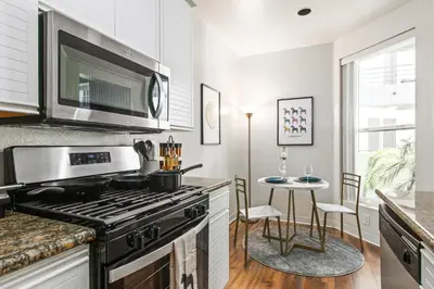 a kitchen with a stove and a table with chairs at Cozy Oasis in Marina Del Rey!Free Swimming Pool and Parking in Los Angeles