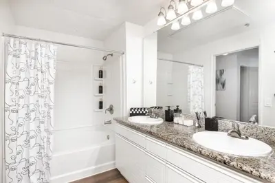 a white bathroom with two sinks and a shower at Cozy Oasis in Marina Del Rey!Free Swimming Pool and Parking in Los Angeles