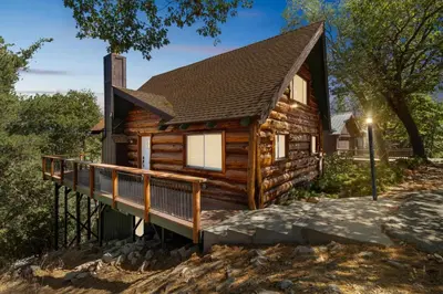 a log cabin with a porch and a deck at Timeless Traditions Arrowhead home in Lake Arrowhead