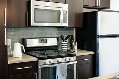 a kitchen with a stove and a microwave at Lovely 1 BD in West Hollywood in Los Angeles