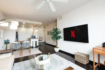 a living room with a tv on a white wall at Lovely 1 BD in West Hollywood in Los Angeles