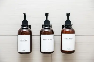 a group of four bottles of liquid on a wall at Lovely 1 BD in West Hollywood in Los Angeles