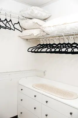 a white laundry room with white cabinets and black shelves at Lovely 1 BD in West Hollywood in Los Angeles