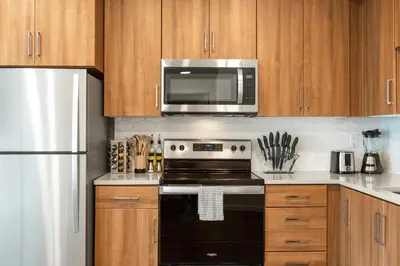 a kitchen with a black stove and a microwave at Beautiful 1BR Apt in Hollywood w Pool and Parking in Los Angeles