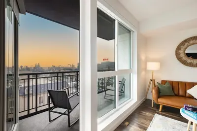 a living room with a view of the city at Beautiful 1BR Apt in Hollywood w Pool and Parking in Los Angeles