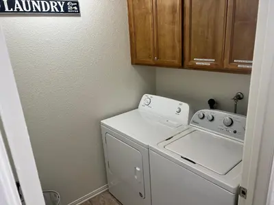 a laundry room with a white washer and dryer at Cheerful 3BR 2BA Sauna Spa Pool Table PPong BBQ More in Lancaster