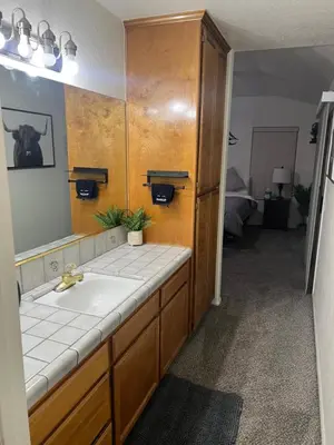 a bathroom with a sink and a mirror at Cheerful 3BR 2BA Sauna Spa Pool Table PPong BBQ More in Lancaster