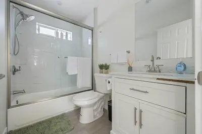 a white bathroom with a shower and a toilet at Serene Home in Central Burbank in Burbank