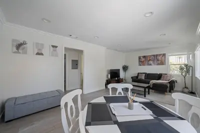 a living room with a table and a couch at Serene Home in Central Burbank in Burbank