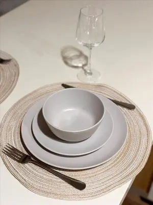 a table with a white bowl and plates and a glass at Cozy 1BR apt in Hollywood w Pool, Gym and Parking in Los Angeles