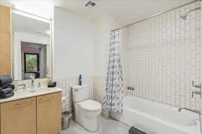 a bathroom with a toilet and a tub and a sink at Cozy 1BR apt in Hollywood w Pool, Gym and Parking in Los Angeles