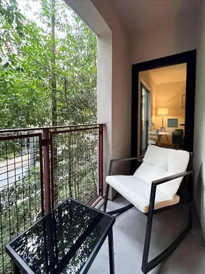 a balcony with a white chair and a table at Cozy 1BR apt in Hollywood w Pool, Gym and Parking in Los Angeles